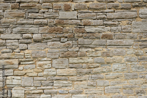 Background texture of a stone wall from an old gray stone