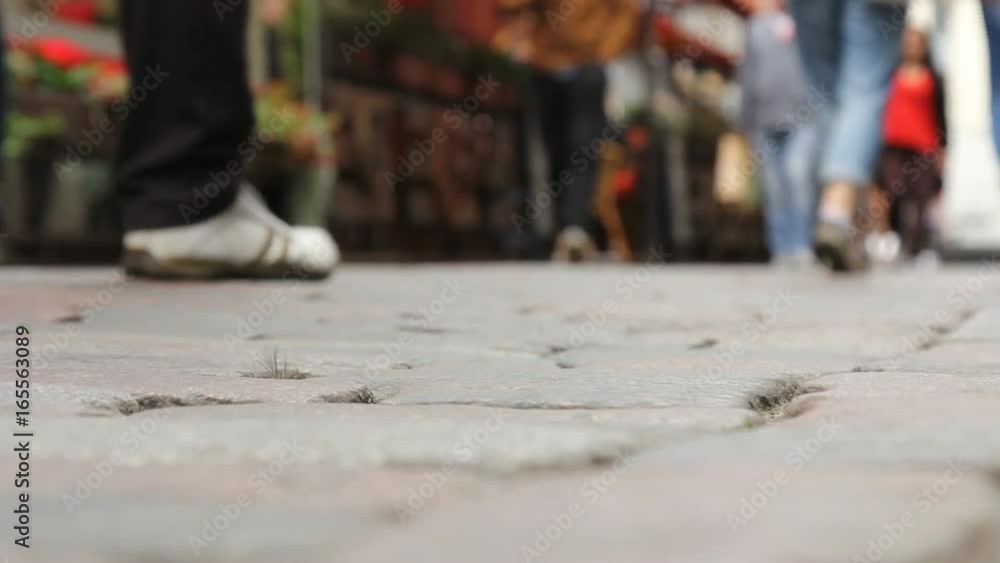 Cobbled street. Crowd people, Businessmen, Businesswomen, Workers and Children on the background walking on the road, street from cobblestones. 4 Cobbled street. Crowd people, Businessmen, Businesswomen, Workers and Children on the background walking on the road, street from cobblestones. 4