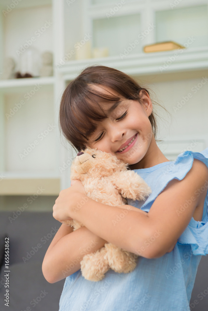 child girl playing with Teddy Bear in living room at home child girl playing with Teddy Bear in living room at home