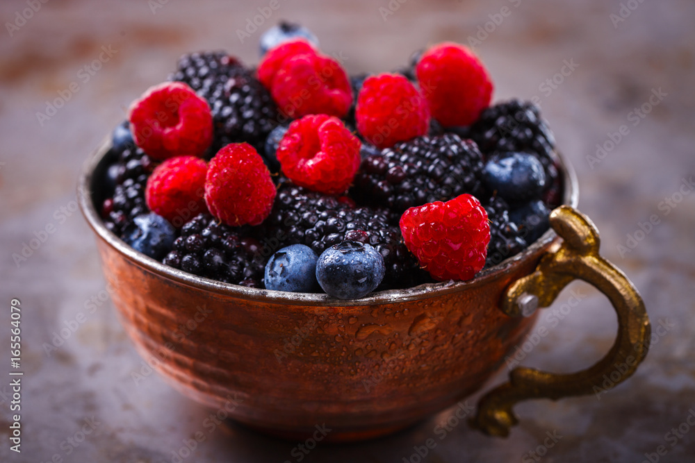 Berry Fresh in a copper cup on the Metal Background. Blackberries,Bramble,raspberry with mint.Food or Healthy diet concept.Super Food.Vegetarian.Copy space for Text.selective focus. Berry Fresh in a copper cup on the Metal Background. Blackberries,Bramble,raspberry with mint.Food or Healthy diet concept.Super Food.Vegetarian.Copy space for Text.selective focus.