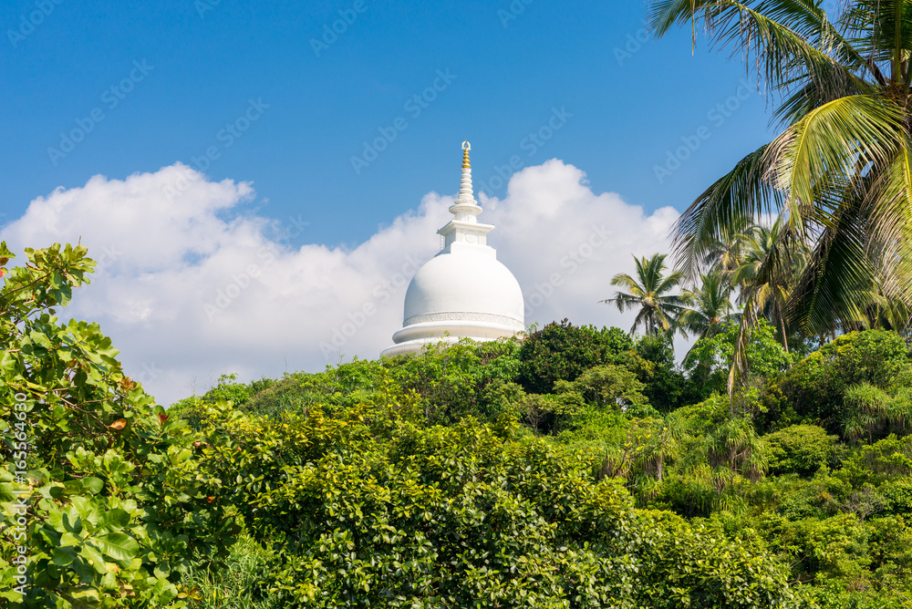 The hemispherical dome named Stupa, from the Japanese Peace Pagoda on top of the Rumassala hill in the Jungle. The Buddhist monastery exists since 2004 and is situated opposite side of the city Gall The hemispherical dome named Stupa, from the Japanese Peace Pagoda on top of the Rumassala hill in the Jungle. The Buddhist monastery exists since 2004 and is situated opposite side of the city Gall
