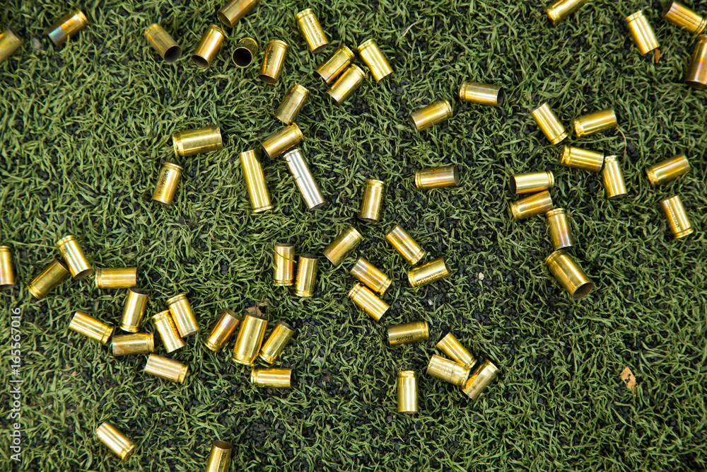 bullet shells ground. Cases of bullets lying on the floor of artificial ...