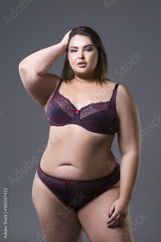 Plus size fashion model in underwear, young fat woman on gray background, overweight female body © staras