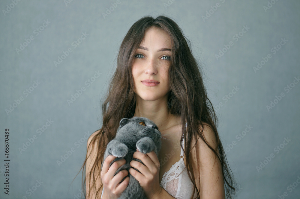 Beautiful brunette girl in underclothes with cat resting at home Beautiful brunette girl in underclothes with cat resting at home