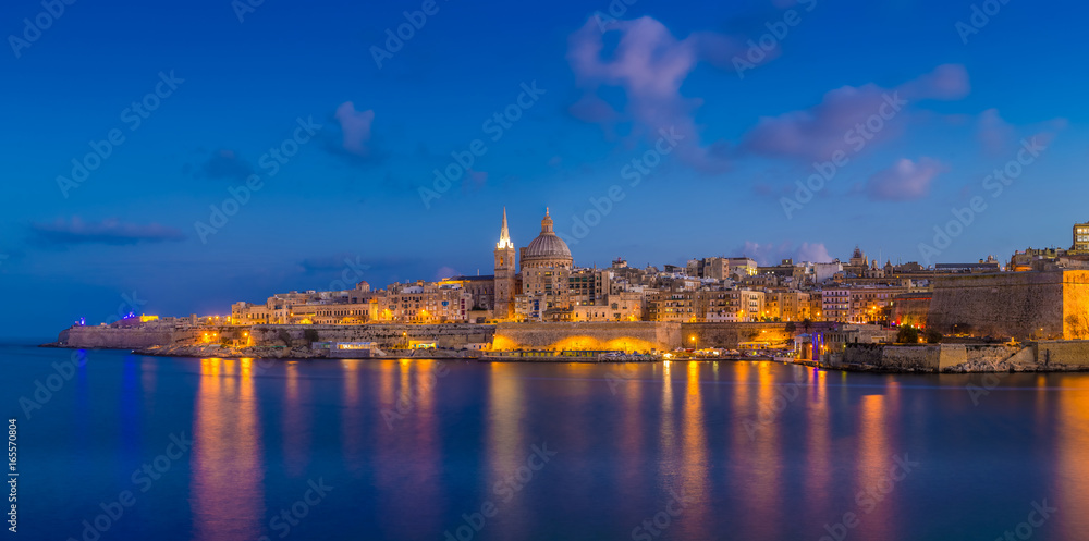 Valletta, Malta - Panoramic skyline view of the famous St.Paul's Cathedral and the city of Valletta at blue hour