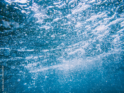 Underwater wave in tropical sea and bubbles. Water texture in ocean