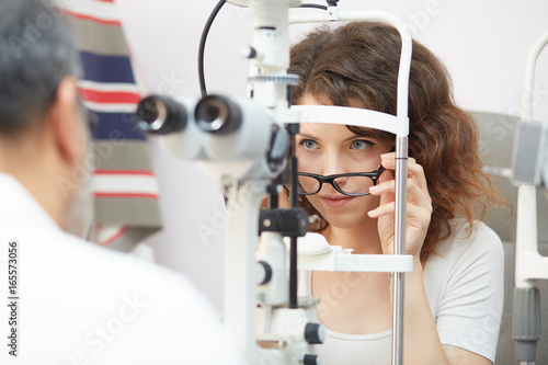 Fototapeta Naklejka Na Ścianę i Meble -  pretty young woman having her eyes examined by an eye doctor