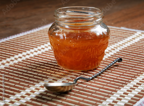 Jam jar with a spoon on a close-up table