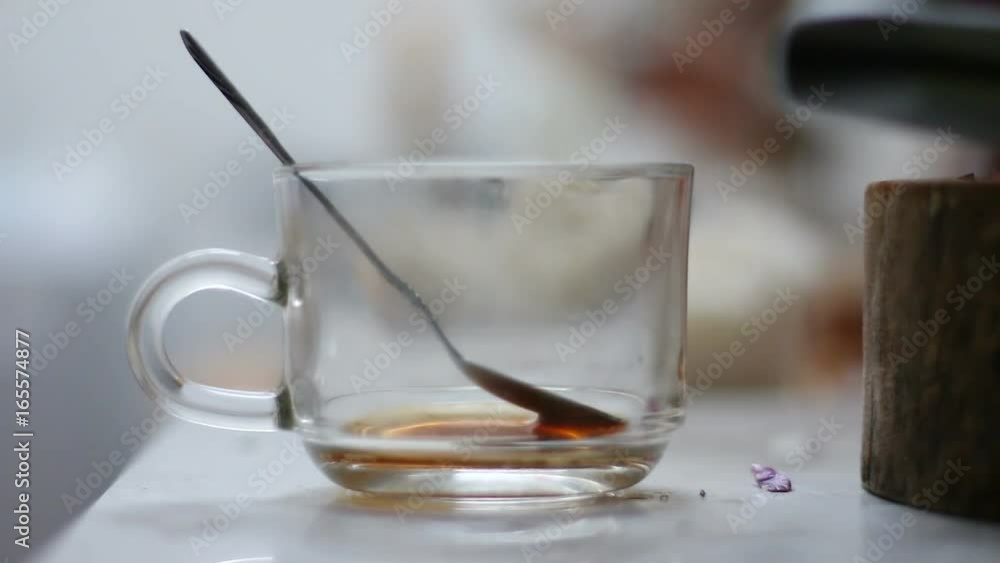 Close up shot of drop tea spoon on dirty clear glass coffee cup shallow depth of field Close up shot of drop tea spoon on dirty clear glass coffee cup shallow depth of field
