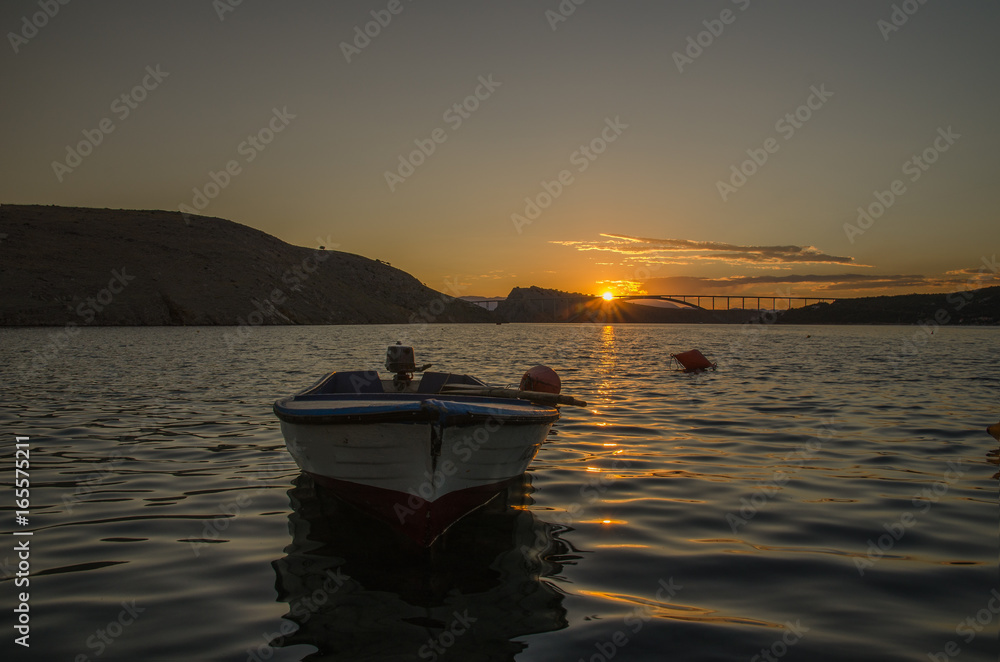Boat on the Adriatic sea with Krk bridge on the background / Croatia Boat on the Adriatic sea with Krk bridge on the background / Croatia