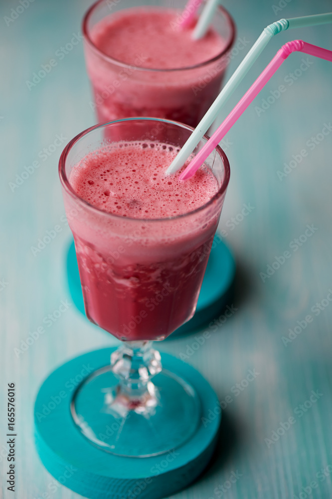 Fresh cool smoothie in a glass with a stem. Delicious and healthy Breakfast. Of cherries and strawberries