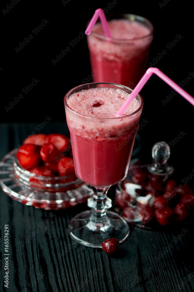 Fresh cool smoothie in a glass with a stem. Delicious and healthy Breakfast. Of cherries and strawberries Fresh cool smoothie in a glass with a stem. Delicious and healthy Breakfast. Of cherries and strawberries