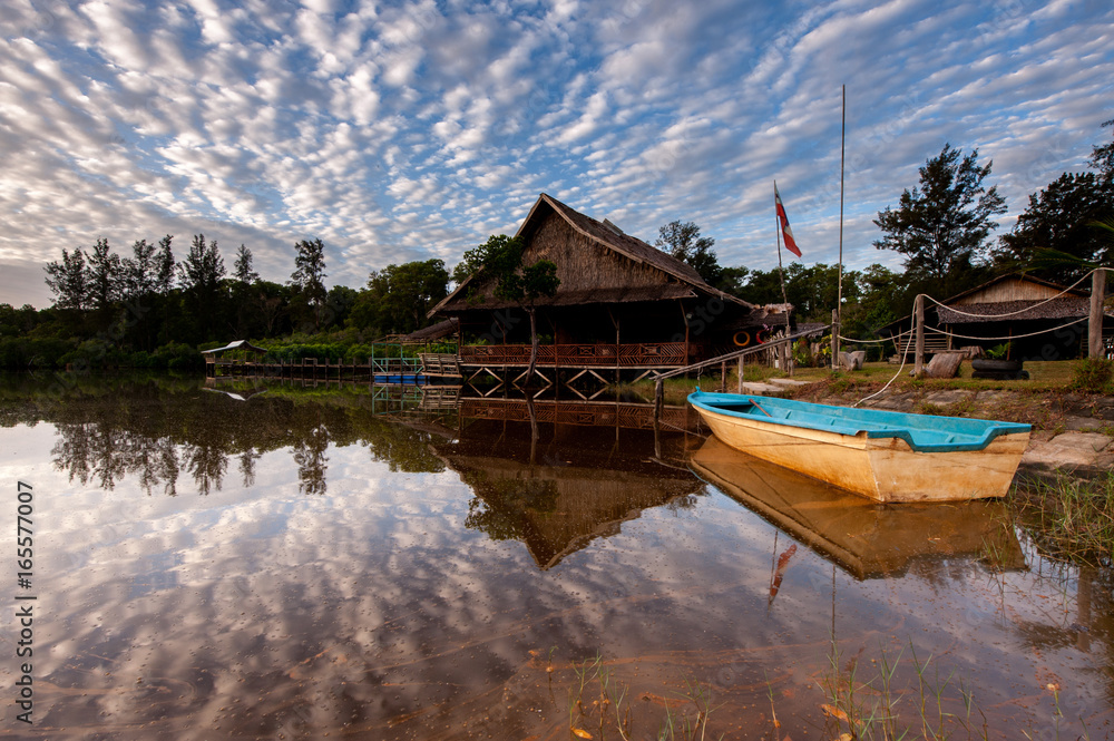 Fototapeta premium traditional house by the lake with reflection
