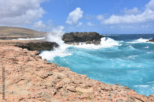 Splashing Ocean Waves with Rocks Near Andicuri Beach photo