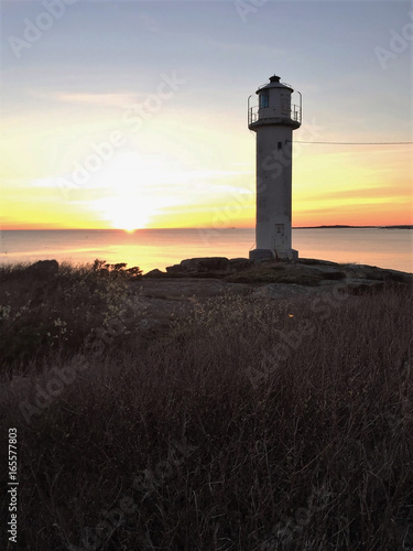 White lighthouse at swedish westcoast in sunset