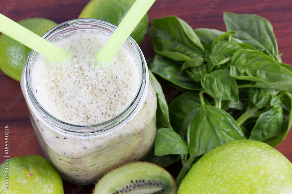 Green smoothie of kiwi,banana,Apple on a wooden background Green smoothie of kiwi,banana,Apple on a wooden background