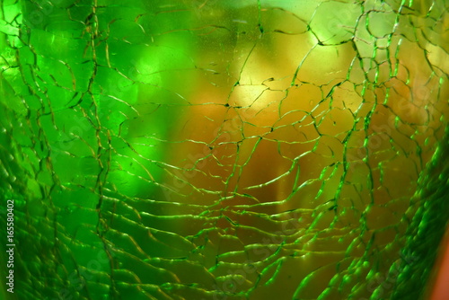 Close-up dark green glass  texture with crackles . Glass reflecting light.