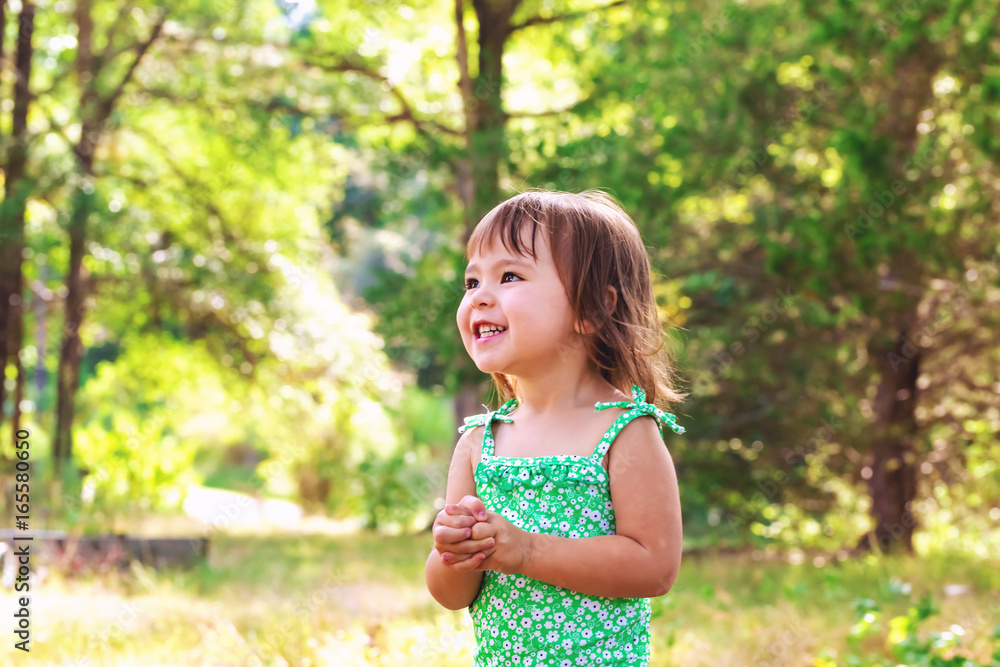 Happy toddler girl wearing bathing suit playing outside Happy toddler girl wearing bathing suit playing outside