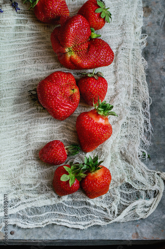 Fresh ripe organic strawberries prepared for making jam on gauze over gray metal background. Preserving concept. Top view. Rustic style, day light