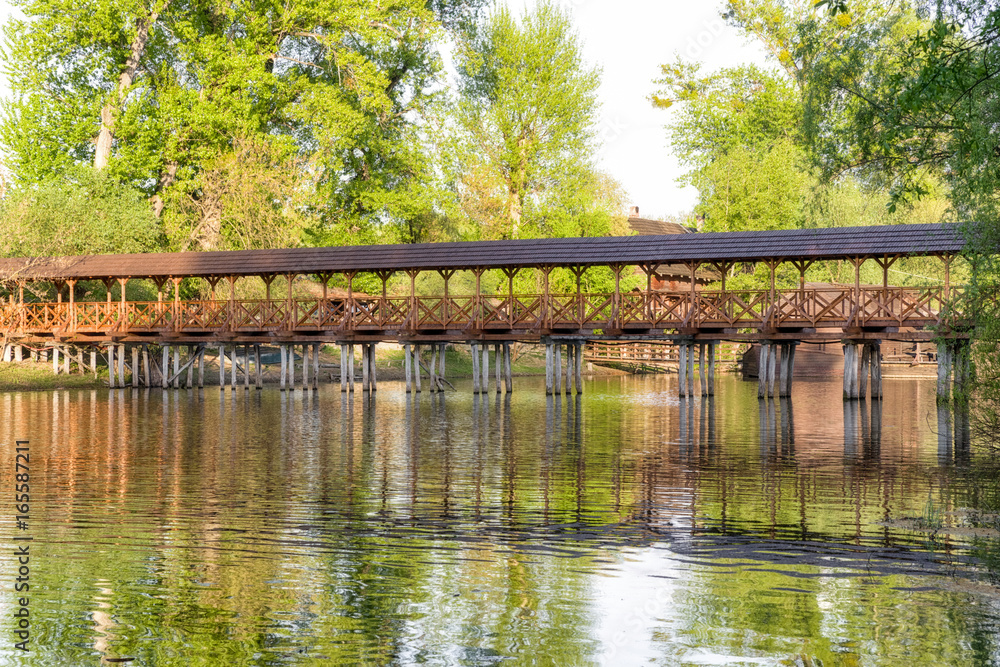 wooden pedestrian bridge over river in Kolarovo, Slovakia