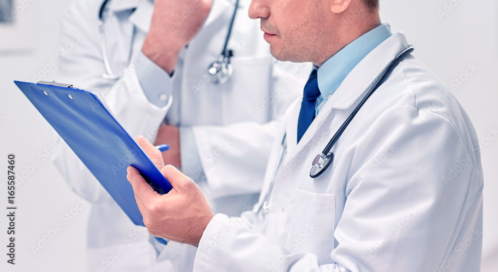 close up of doctors with clipboard at hospital close up of doctors with clipboard at hospital