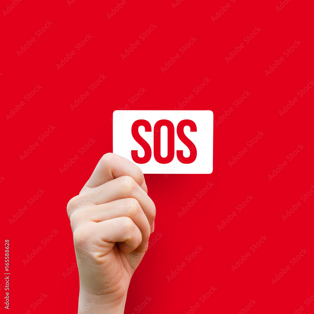 In the hand card with the inscription sos . In the hand card with the inscription sos .