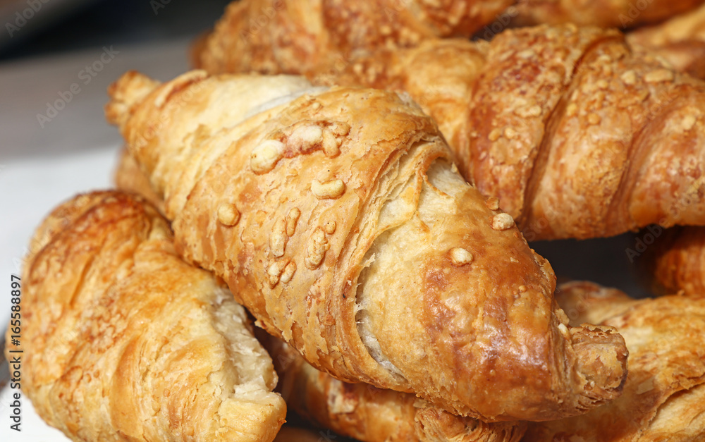 Freshly baked golden croissants close up Freshly baked golden croissants close up