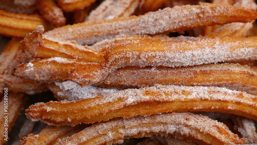 Sweet fresh churros snack with sugar close up
