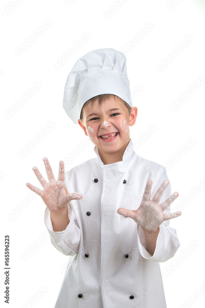 Cute playful little chef with flour on his hands Cute playful little chef with flour on his hands