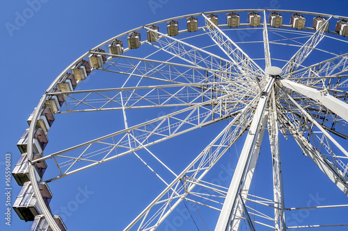 Ferris wheel perspective against blue sky