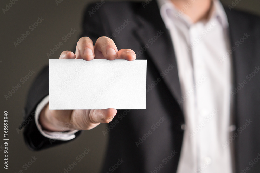 Business man holding empty white business card. Business man holding empty white business card.