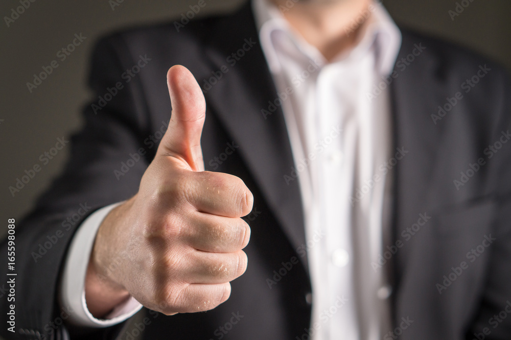 Business man showing thumbs up.