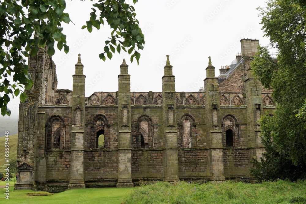 Holyrood Abbey is an Augustinian Abbey that lies in ruins in Edinburgh, Scotland. The Abbey (which is located on the grounds of the Palace of Holyrood, which preceded) was built in 1128 by order of Ki