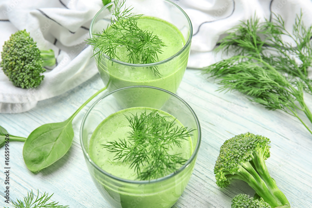 Glasses of fresh vegetable juice on wooden background Glasses of fresh vegetable juice on wooden background