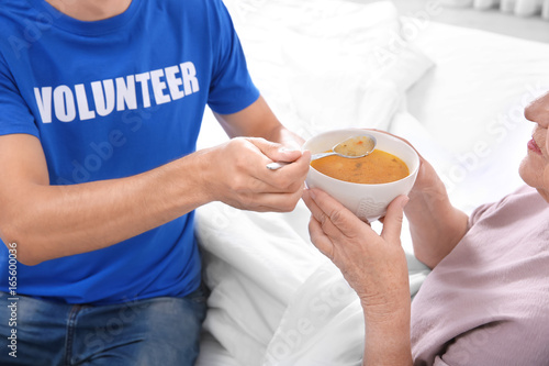Young male volunteer feedin...
