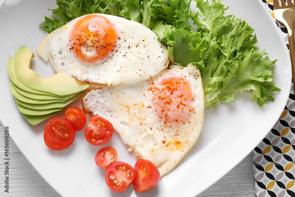 Delicious breakfast with fried eggs on white wooden table Delicious breakfast with fried eggs on white wooden table