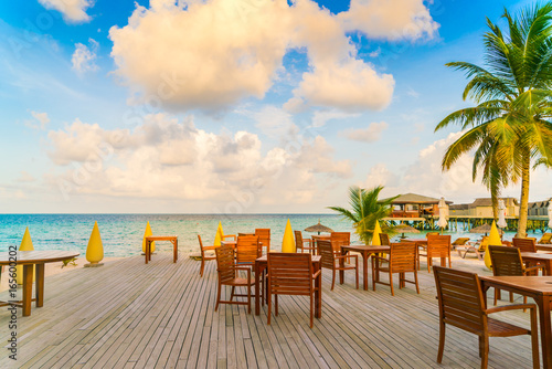 Table and chairs at restaurant in tropical Maldives island .