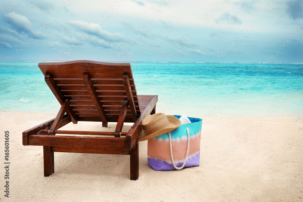 Sun lounger with beach accessories at sea resort