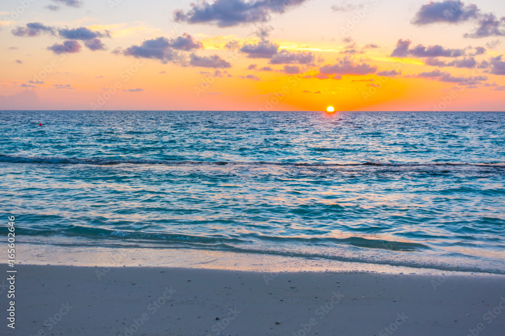 Beautiful sunset with sky over calm sea in tropical Maldives island Beautiful sunset with sky over calm sea in tropical Maldives island