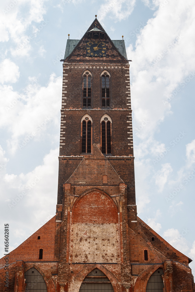 Fototapeta premium Clock tower of the gothic church in Wismar old town, Germany