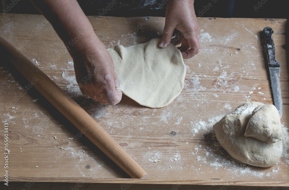 Senior woman roll fresh made pastry, preparing ingrediets for homemade croissants Senior woman roll fresh made pastry, preparing ingrediets for homemade croissants