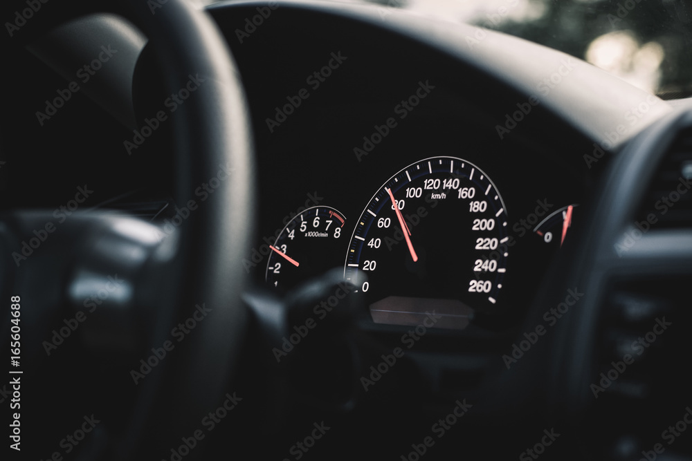 Fototapeta premium Black dark luxury speedometer with red glowing arrow.