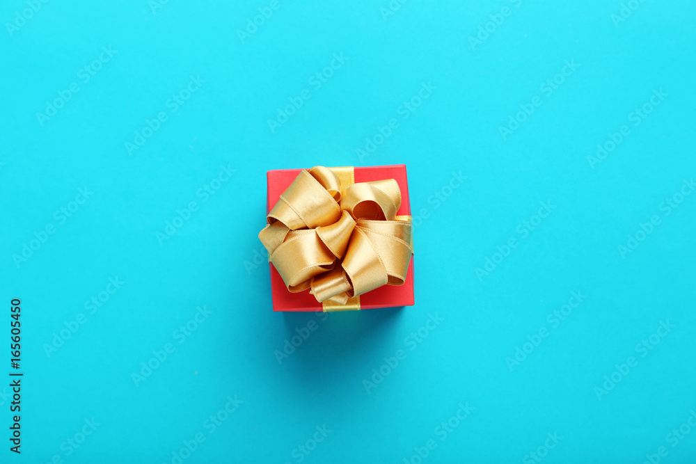 Gift box with ribbon on blue background