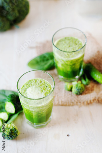 Summer nutritious and refreshing drink, detox, green vegetable smoothie from broccoli, spinach and cucumber on a light background