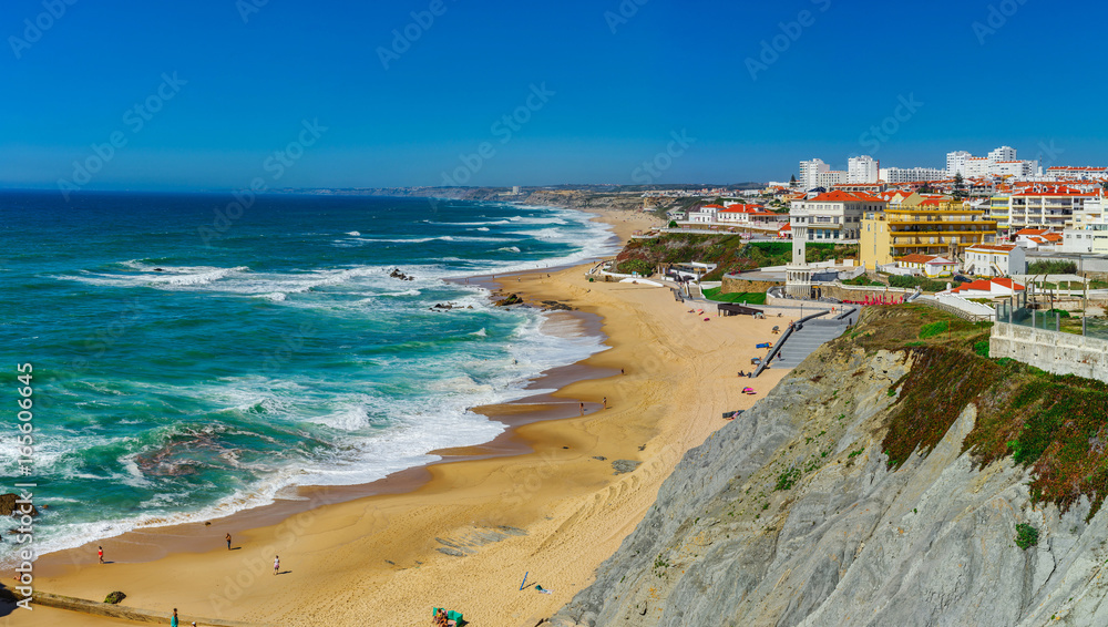 Yellow rocks and sand on portuguese coastline, vivid ocean water