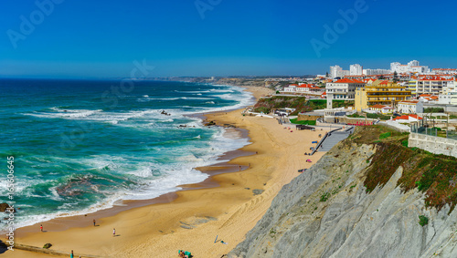 Yellow rocks and sand on portuguese coastline  vivid ocean water