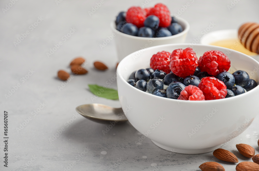 Natural yogurt with fresh berries and honey, healthy breakfast concept, selective focus, copy space Natural yogurt with fresh berries and honey, healthy breakfast concept, selective focus, copy space