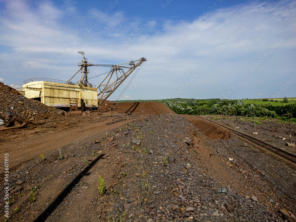 Dumps rock mountains from industrial quarries