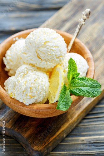 Homemade lemon ice cream in a wooden bowl. photo