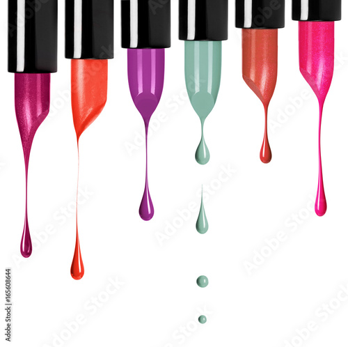 Melting colored lipsticks with falling drops down isolated on white background
